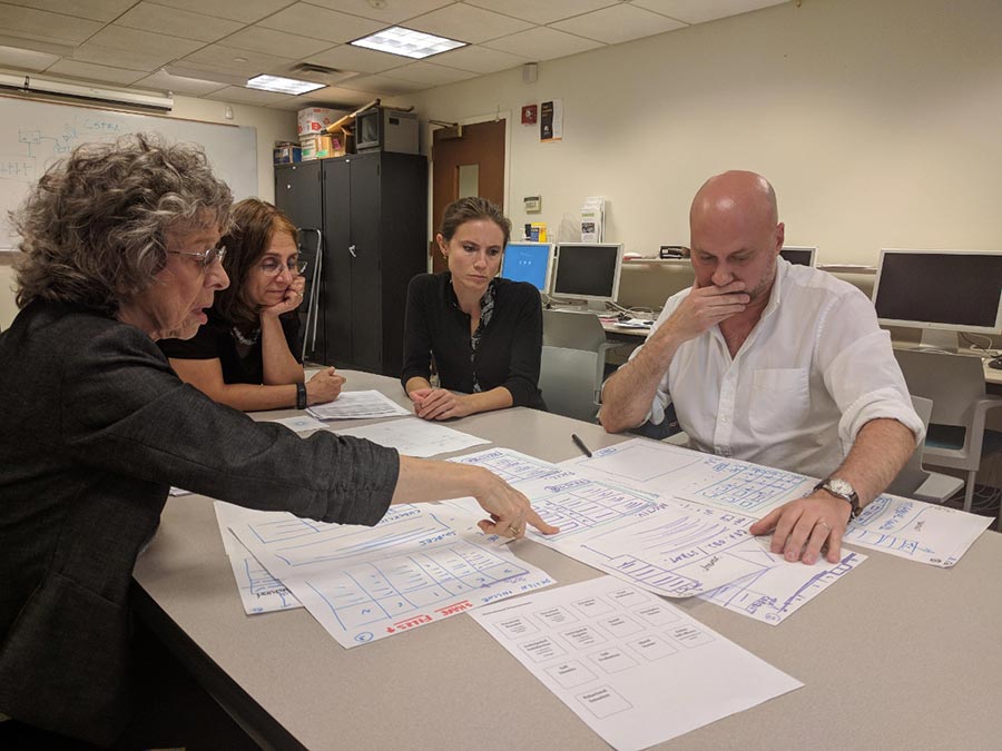 Isobel Contento, Pam Koch, Rachel Paul and Marc Raymond are shown reviewing design documents.